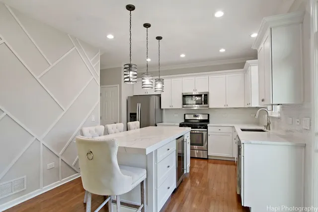 a kitchen with a stove a sink and a refrigerator
