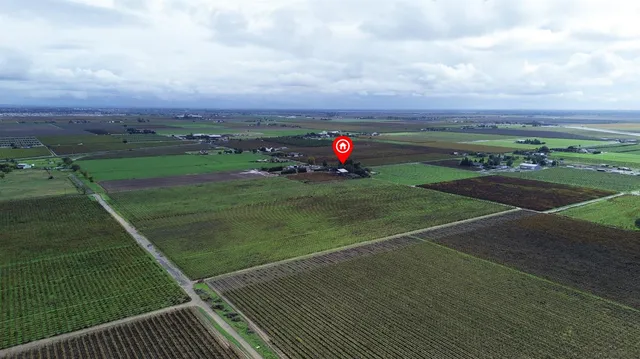 a large kitchen with stainless steel appliances granite countertop a lot of counter space and wooden floor