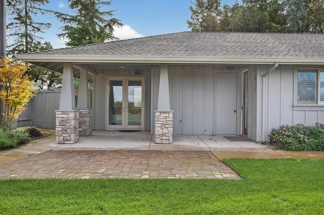 a living room with stainless steel appliances furniture microwave and cabinets