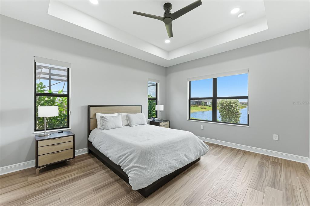 4191 Pegasus Way Naples, FL 34120 - Photo 17 of 48 a bedroom with a large bed chandelier and a window