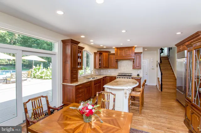 a kitchen with a stove a sink and a wooden cabinets