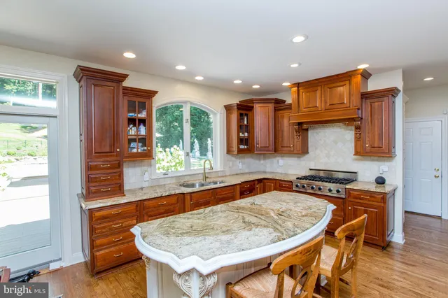 a kitchen with stainless steel appliances granite countertop a stove and more cabinets