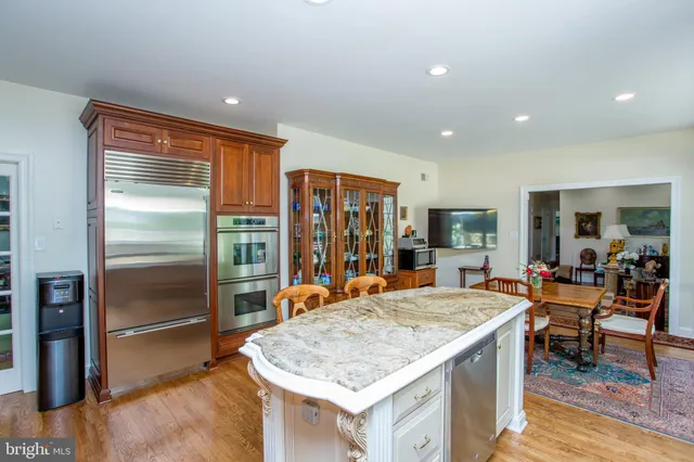 a kitchen with stainless steel appliances granite countertop sink stove and refrigerator