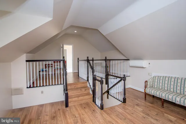 a view of a room with wooden floor and furniture