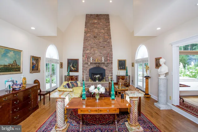 a living room with furniture fireplace and a large window