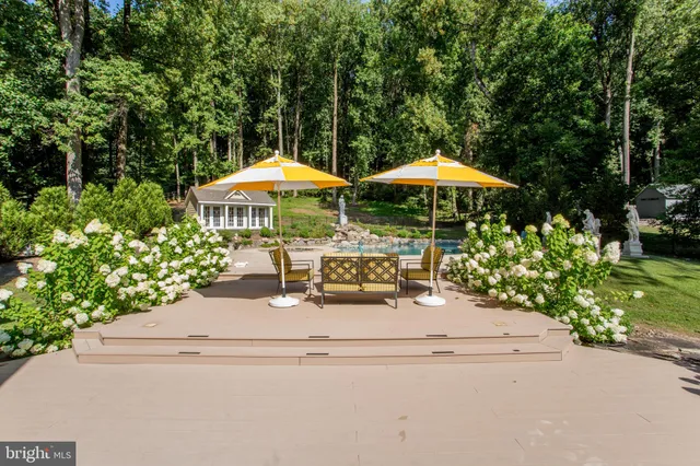 a view of a house with backyard and sitting area
