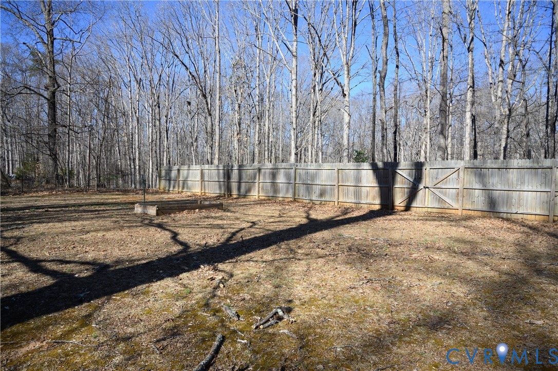 2143 Mountain View Road Powhatan, VA 23139 - Photo 28 of 34 a view of backyard with large tree and wooden fence