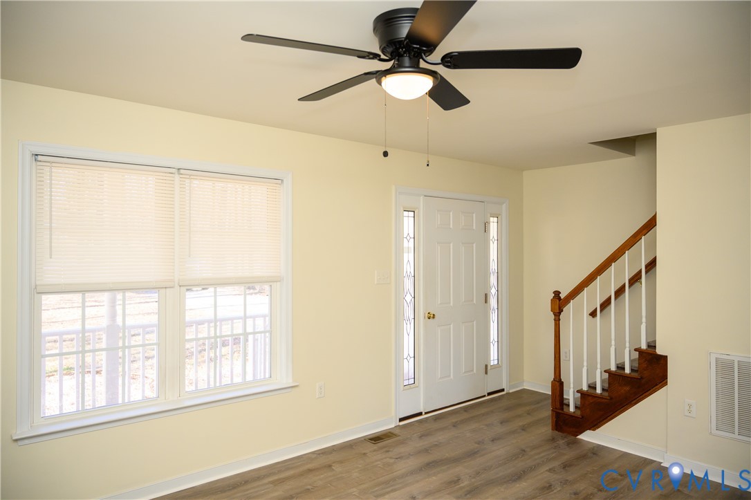 2143 Mountain View Road Powhatan, VA 23139 - Photo 4 of 34 a view of an empty room with wooden floor and a window
