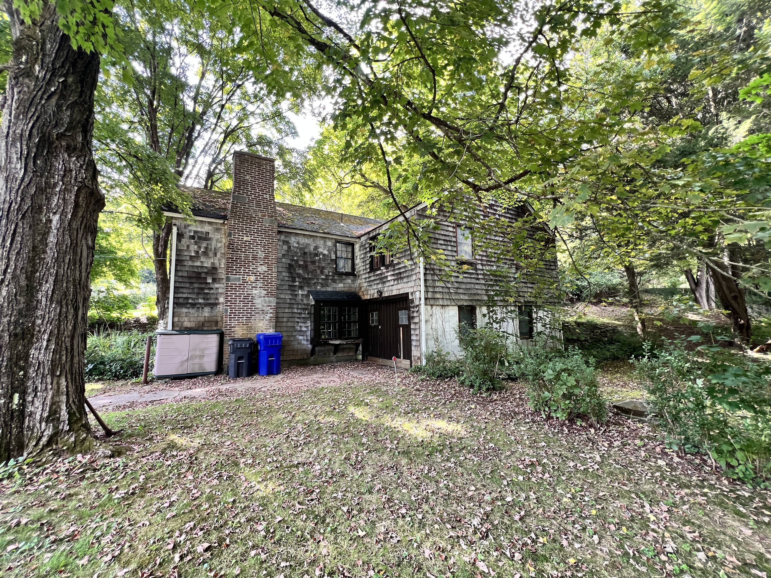 a view of a house with a tree and a yard