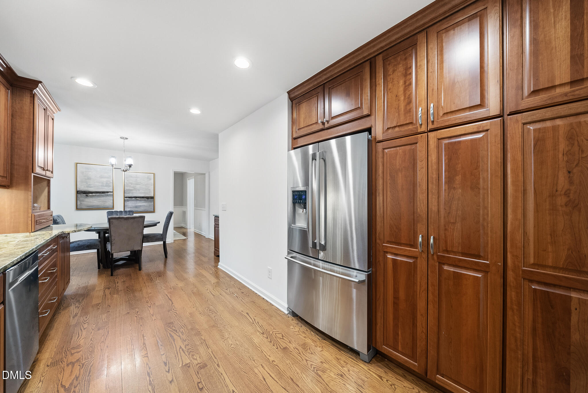 3404 Timberwood Court Raleigh, NC 27606 - Photo 12 of 45 a kitchen with kitchen island wooden floors appliances and furniture