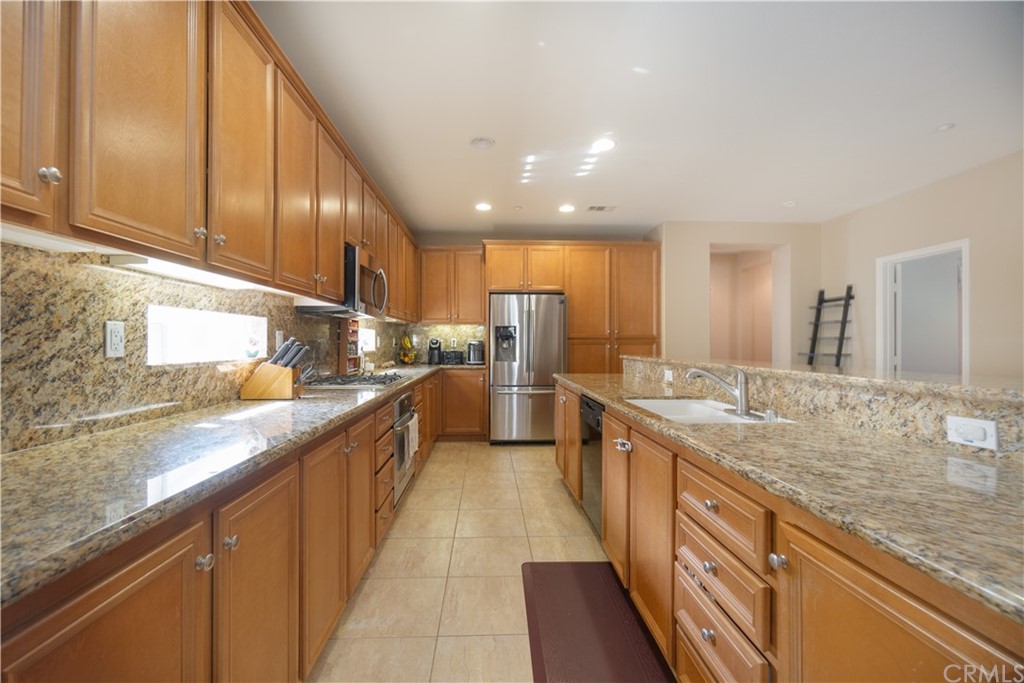 8360 Ranger Lane Chino, CA 91708 - Photo 1 of 1 a large kitchen with stainless steel appliances and a sink