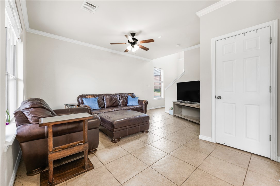 1425 West Villa Maria Road, Unit 1004 Bryan, TX 77801 - Photo 3 of 23 a living room with furniture and a flat screen tv