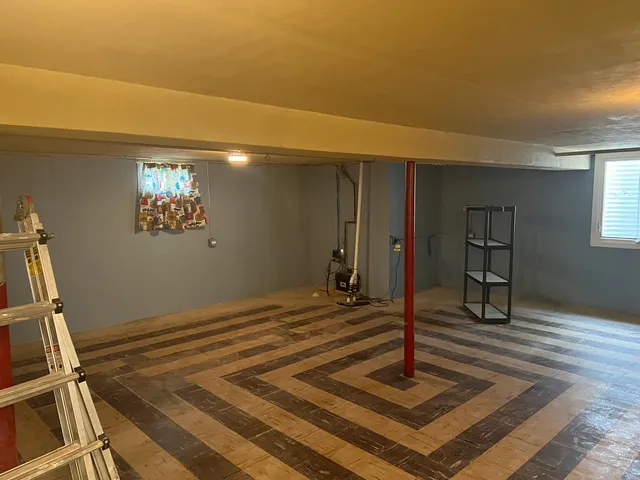 a view of a livingroom with wooden floor and stairs