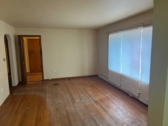 a view of an empty room and wooden floor