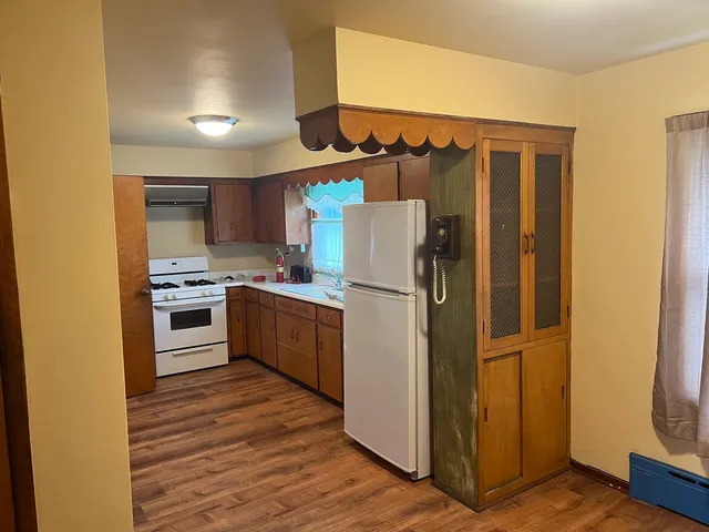 a kitchen with a refrigerator a stove and a microwave