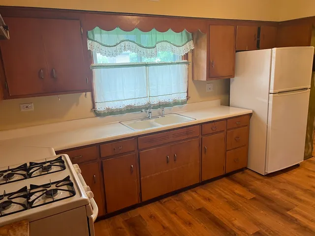 a kitchen with a refrigerator and a stove