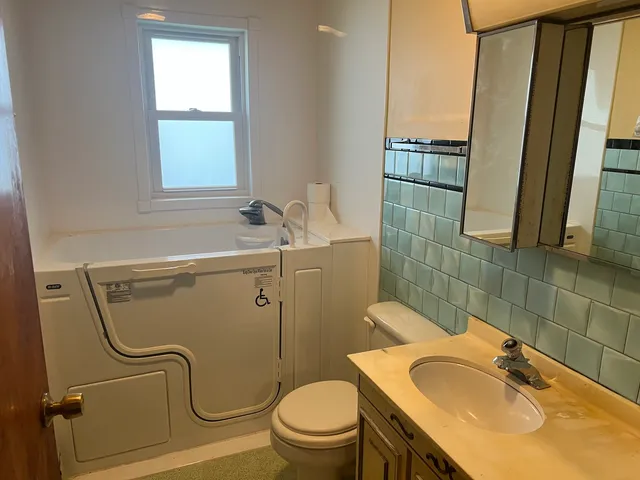 a bathroom with a sink a mirror and a toilet