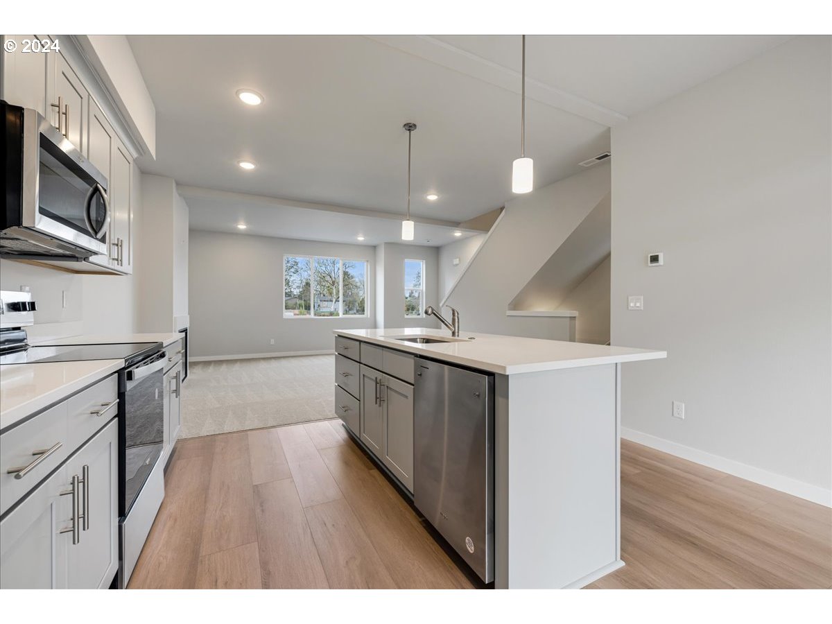 1485 North Chehalis Lane Newberg, OR 97132 - Photo 15 of 38 a kitchen with a sink stainless steel appliances and cabinets