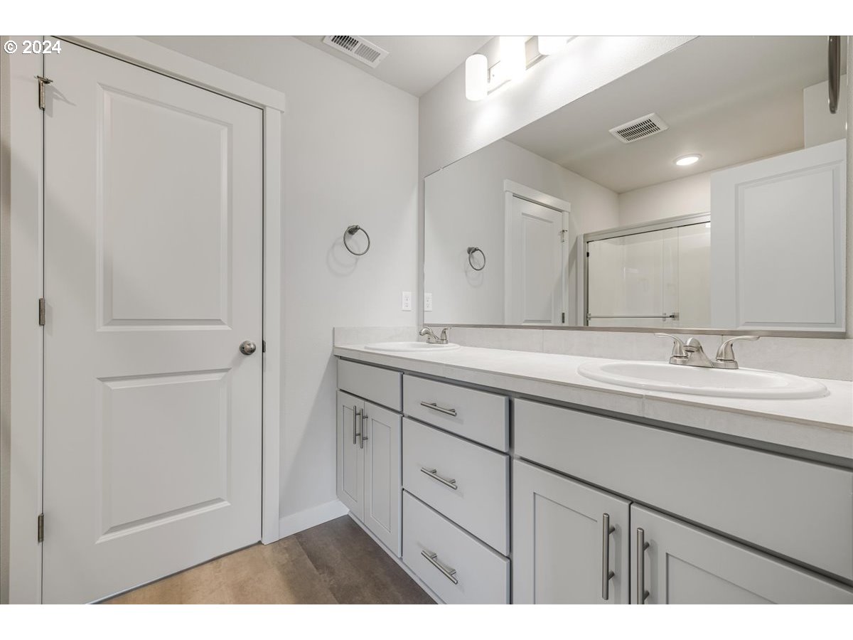 1485 North Chehalis Lane Newberg, OR 97132 - Photo 26 of 38 a bathroom with a double vanity sink and mirror