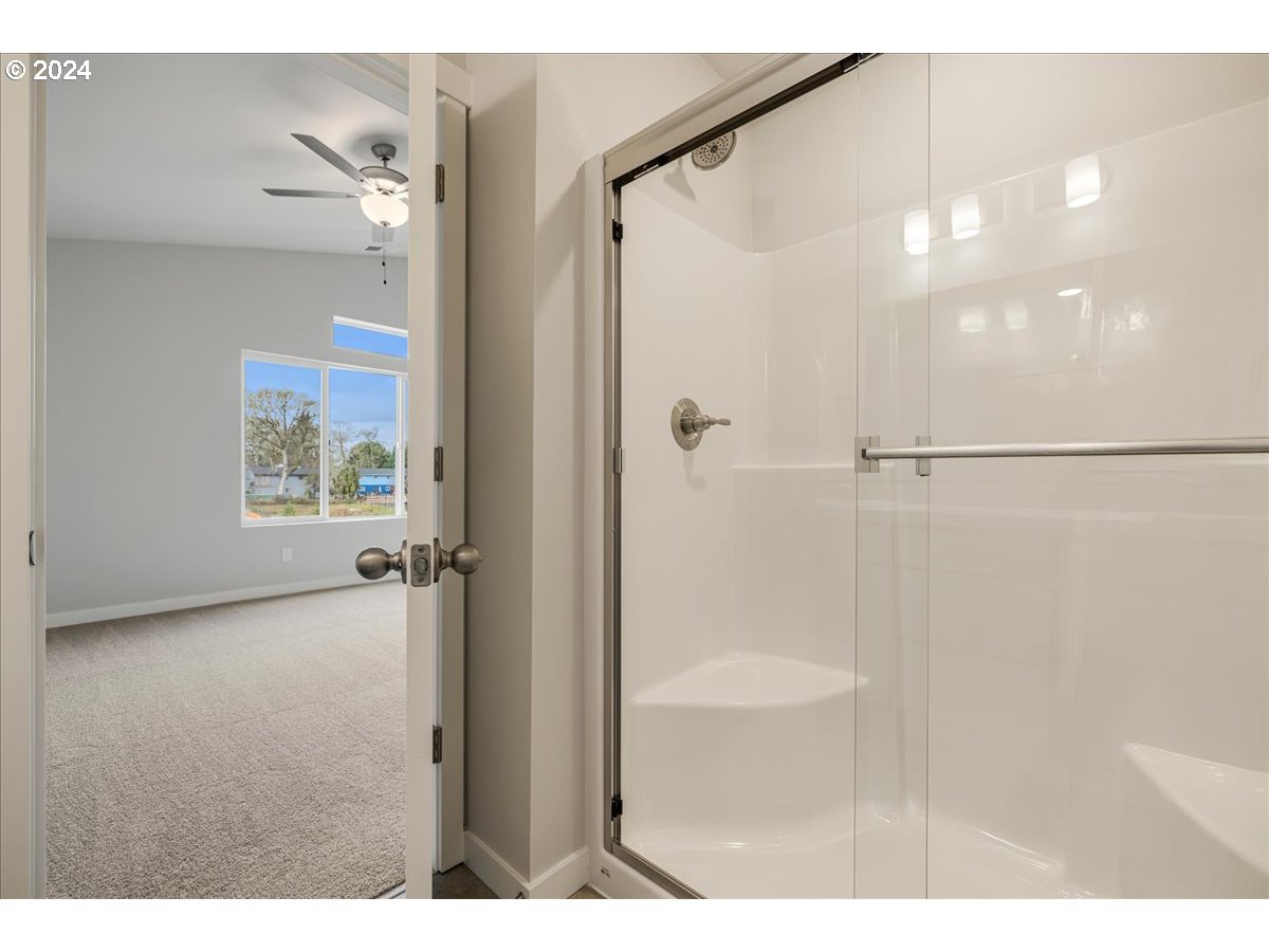 1485 North Chehalis Lane Newberg, OR 97132 - Photo 27 of 38 a bathroom with a glass shower door