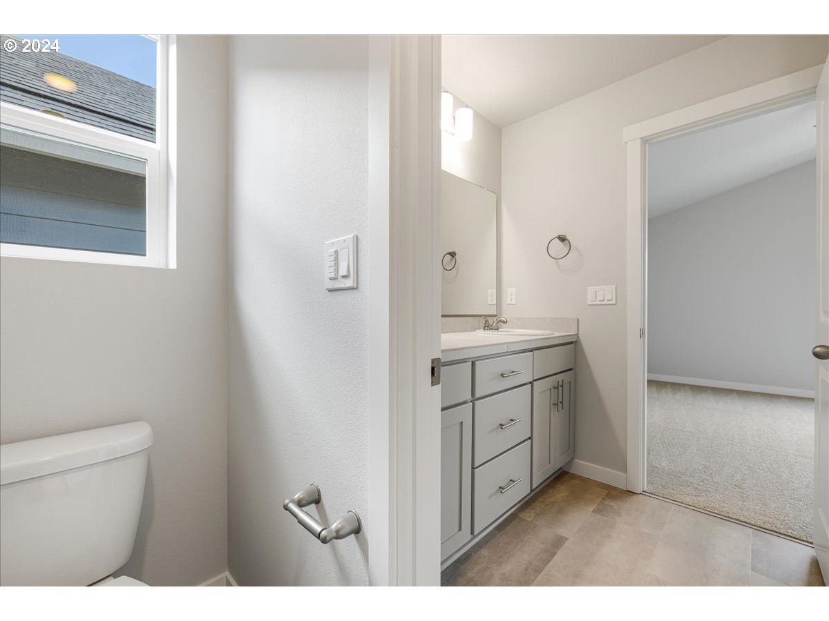 1485 North Chehalis Lane Newberg, OR 97132 - Photo 28 of 38 a bathroom with a granite countertop sink mirror and toilet
