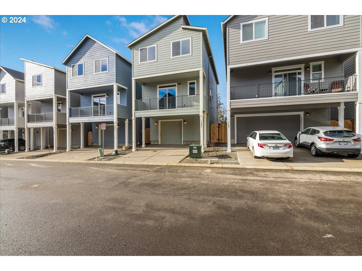 1485 North Chehalis Lane Newberg, OR 97132 - Photo 38 of 38 a front view of a residential apartment building with a yard