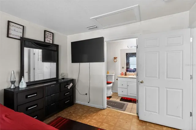 a bathroom with a sink vanity mirror bathtub and toilet
