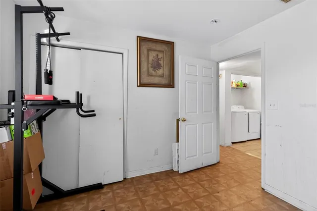 a bedroom with bed and a workspace