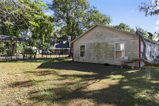 a backyard of a house with a tree