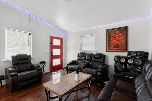 a living room with furniture and wooden floor