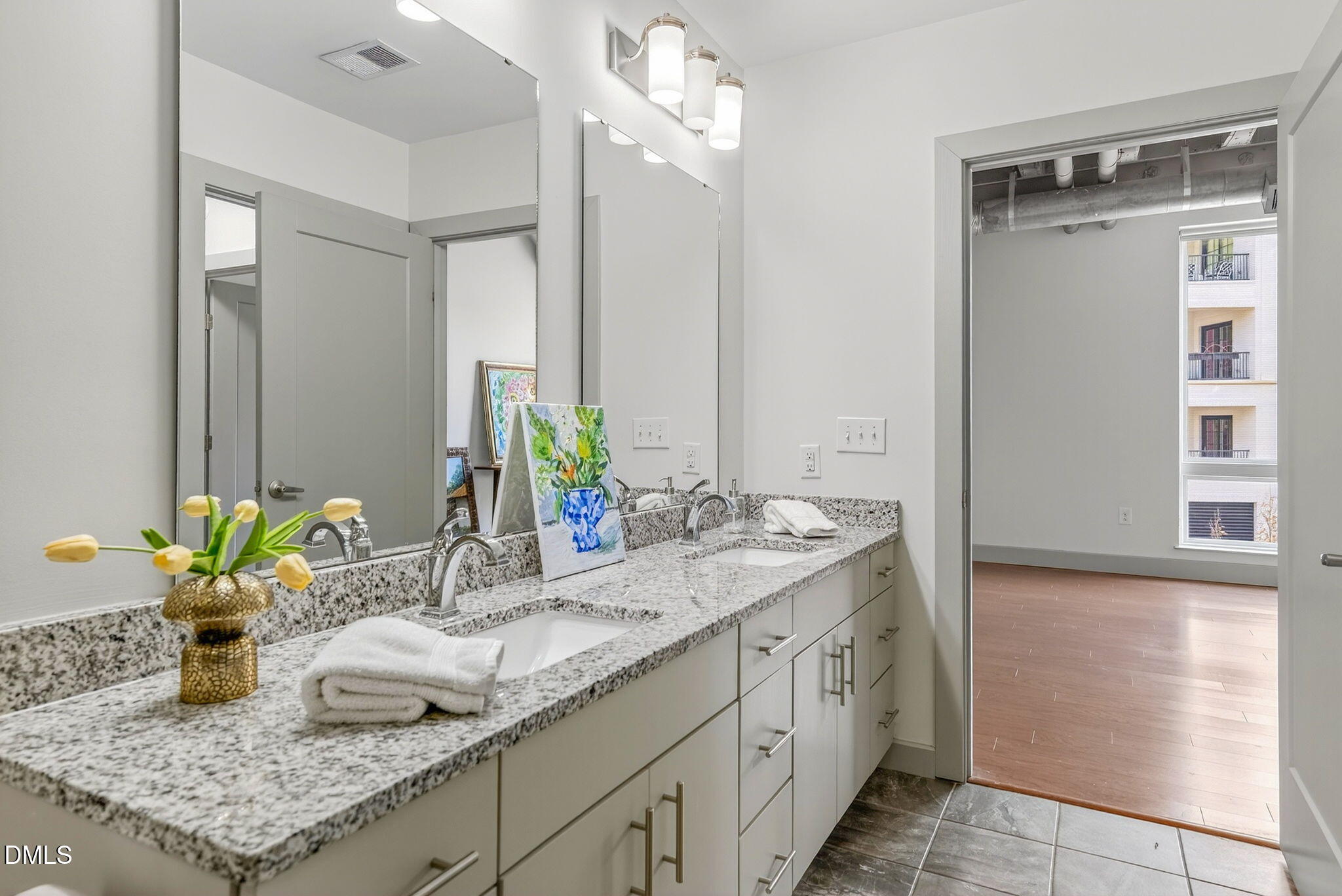 1300 St Marys Street, Unit 203 Raleigh, NC 27605 - Photo 21 of 24 a bathroom with a granite countertop sink and a mirror