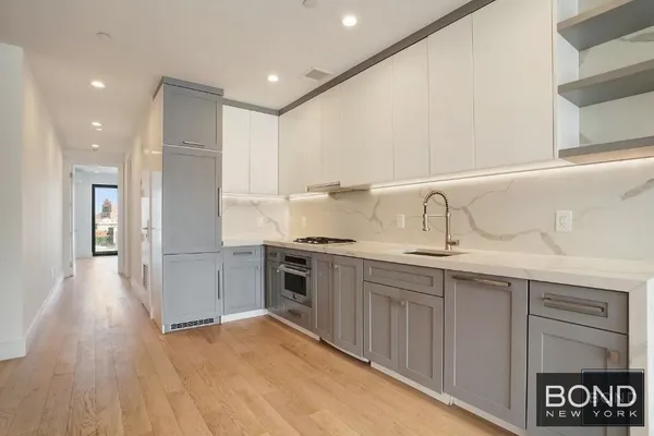 a kitchen with granite countertop a sink and cabinets