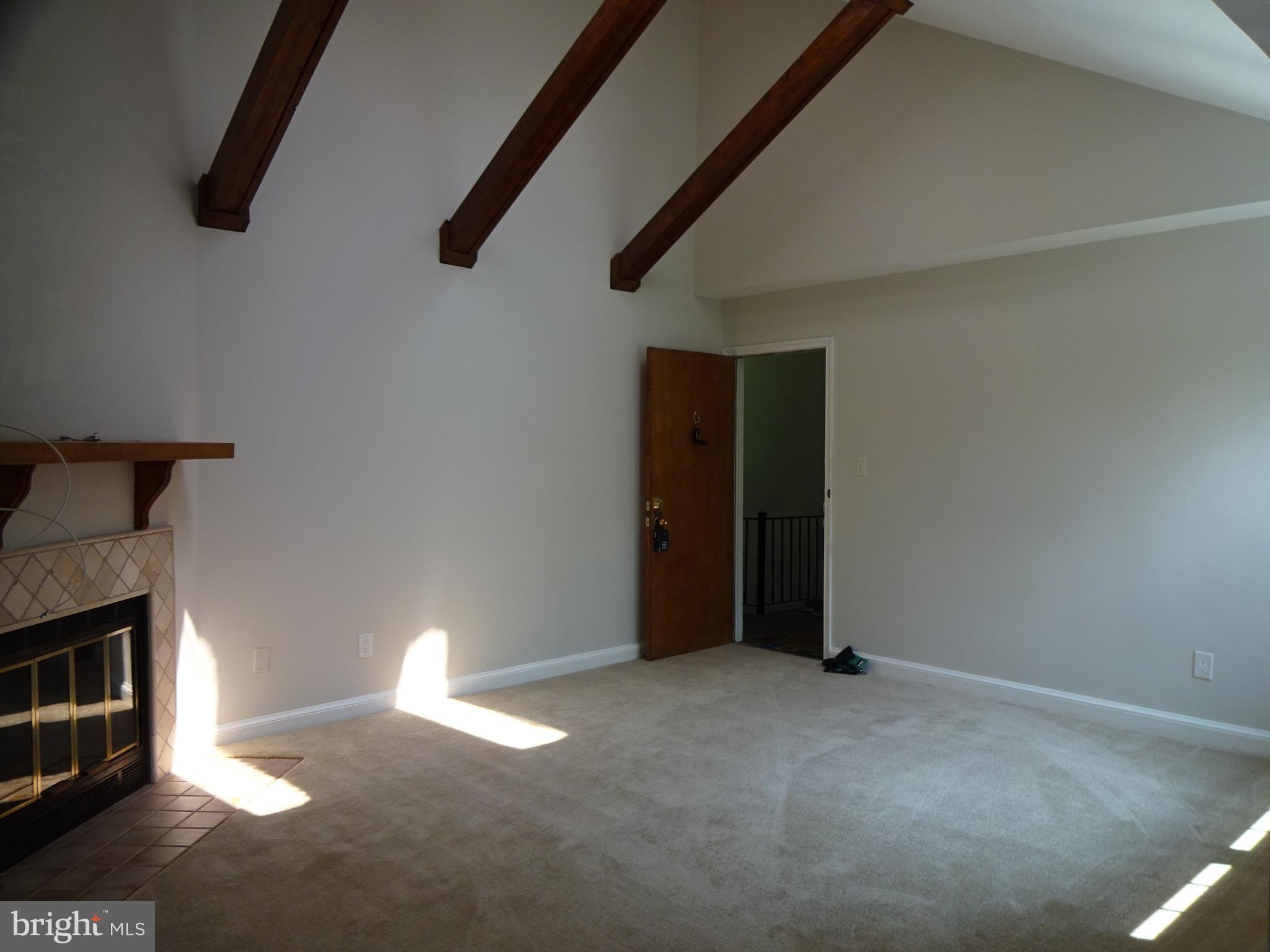 a view of an empty room with a fireplace