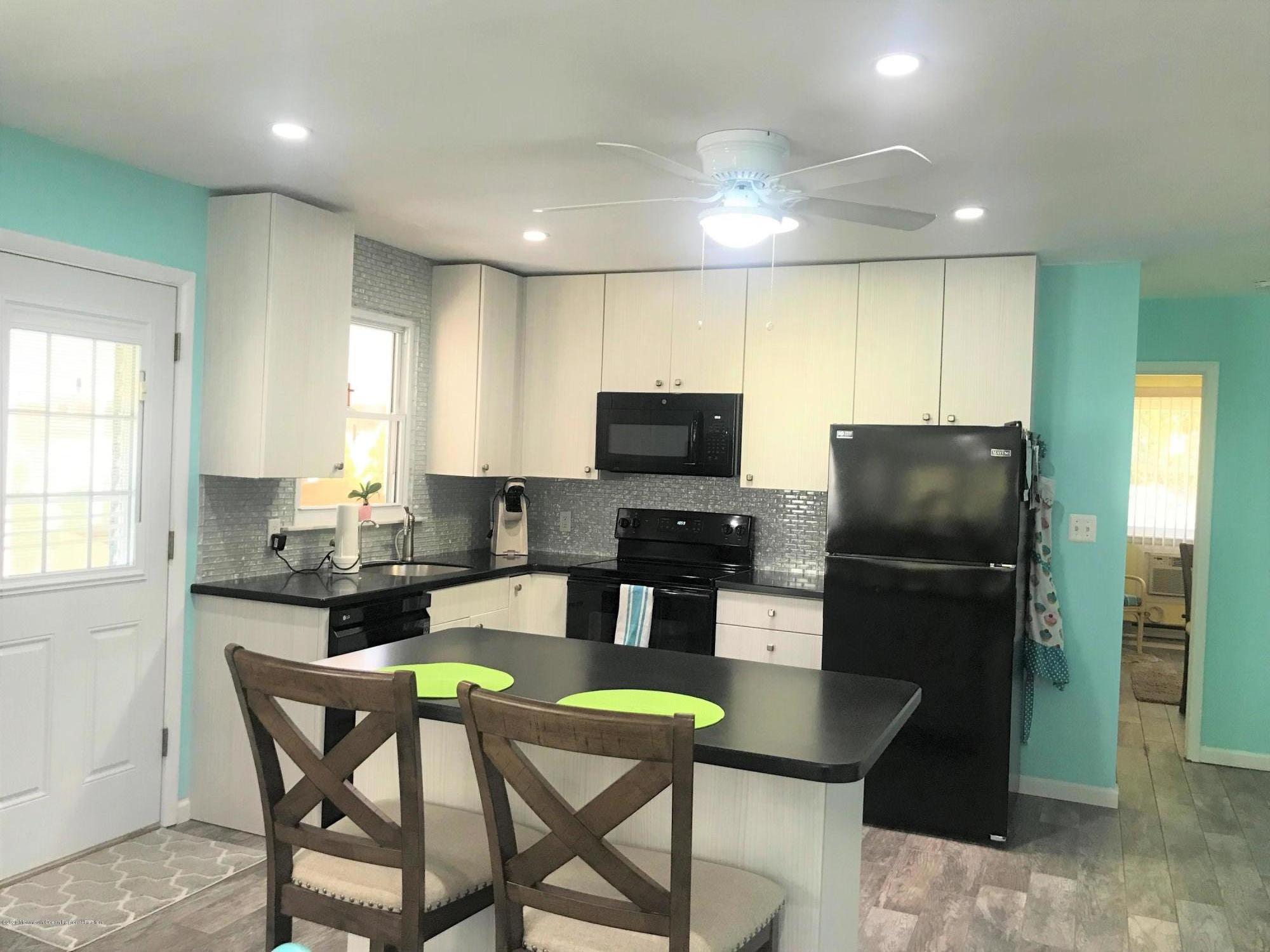 a kitchen with a dining table cabinets and refrigerator