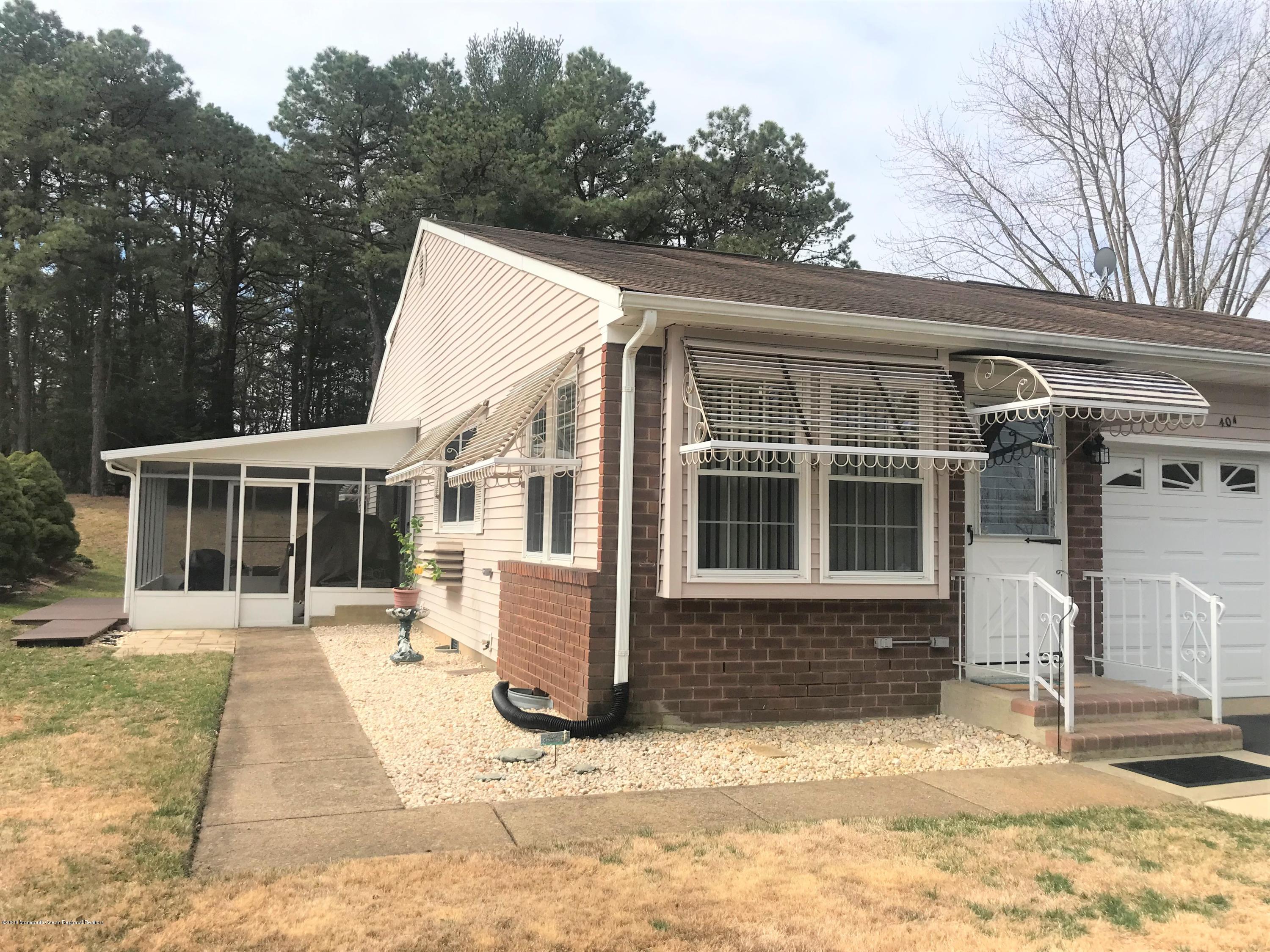 40 A Sunset Road Whiting, NJ 08759 - Photo 13 of 17 a front view of a house with a yard and potted plants