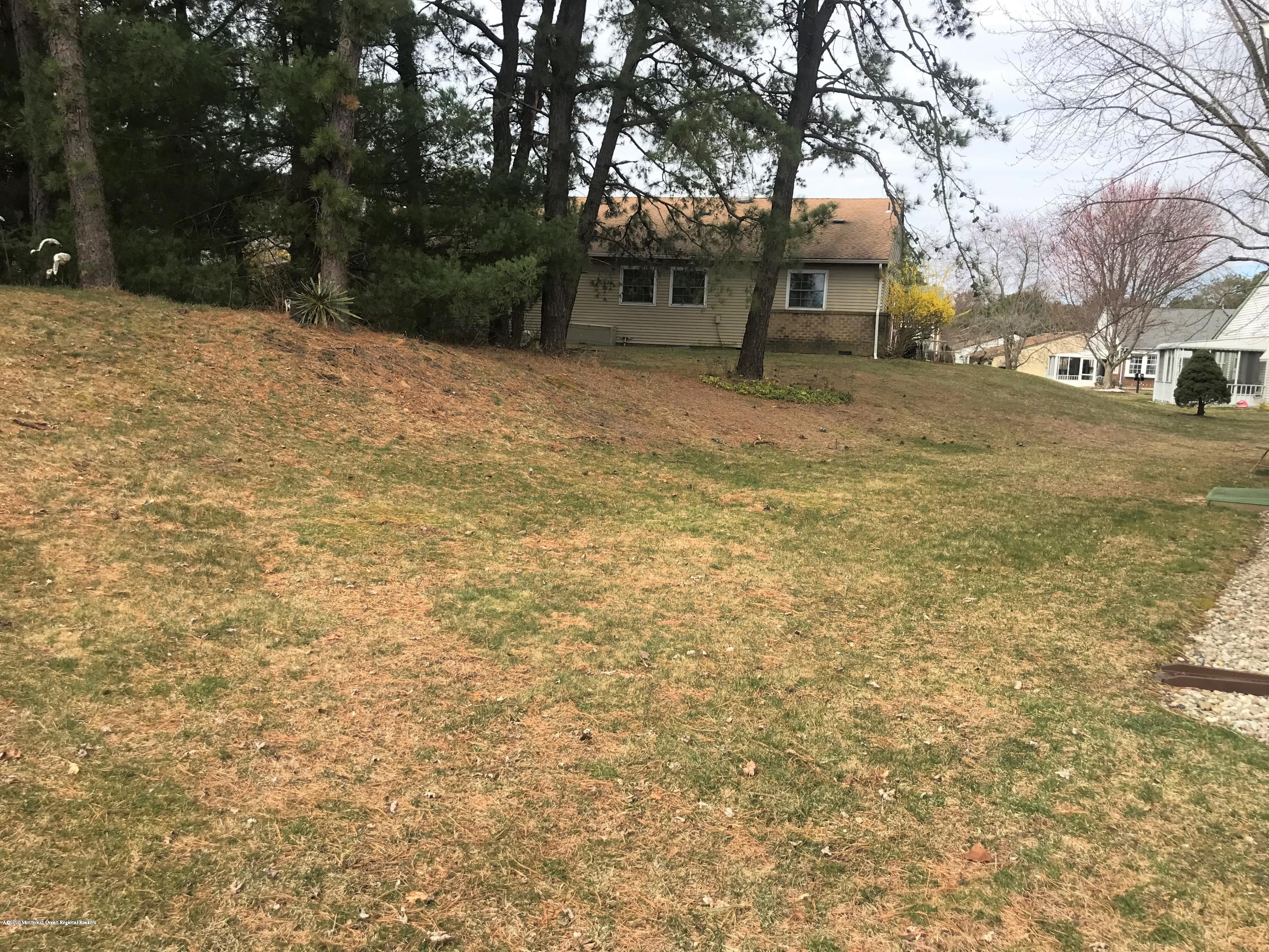 40 A Sunset Road Whiting, NJ 08759 - Photo 17 of 17 a backyard of a house with large trees and outdoor seating