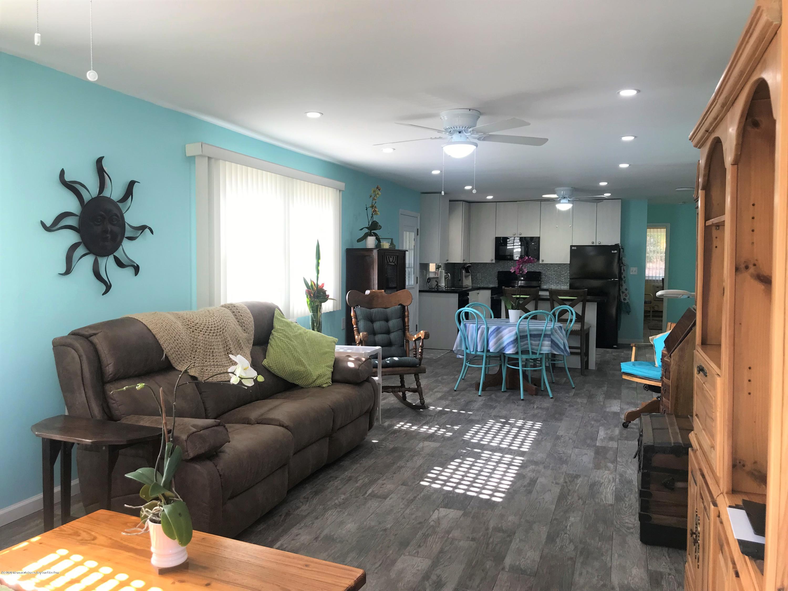 40 A Sunset Road Whiting, NJ 08759 - Photo 4 of 17 a living room with furniture kitchen view and a chandelier