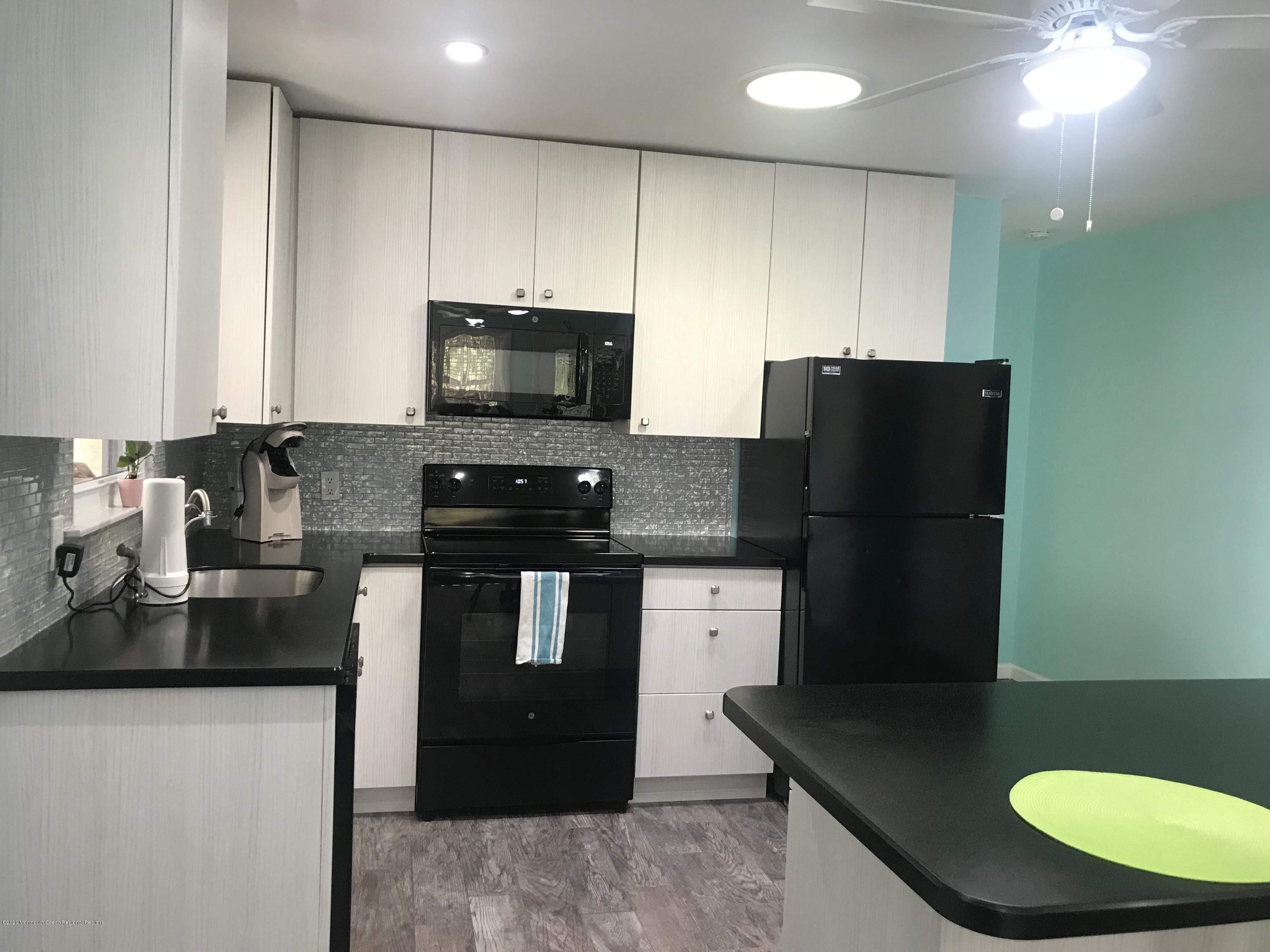 40 A Sunset Road Whiting, NJ 08759 - Photo 6 of 17 a kitchen with stainless steel appliances granite countertop a refrigerator a stove a sink a microwave and a refrigerator