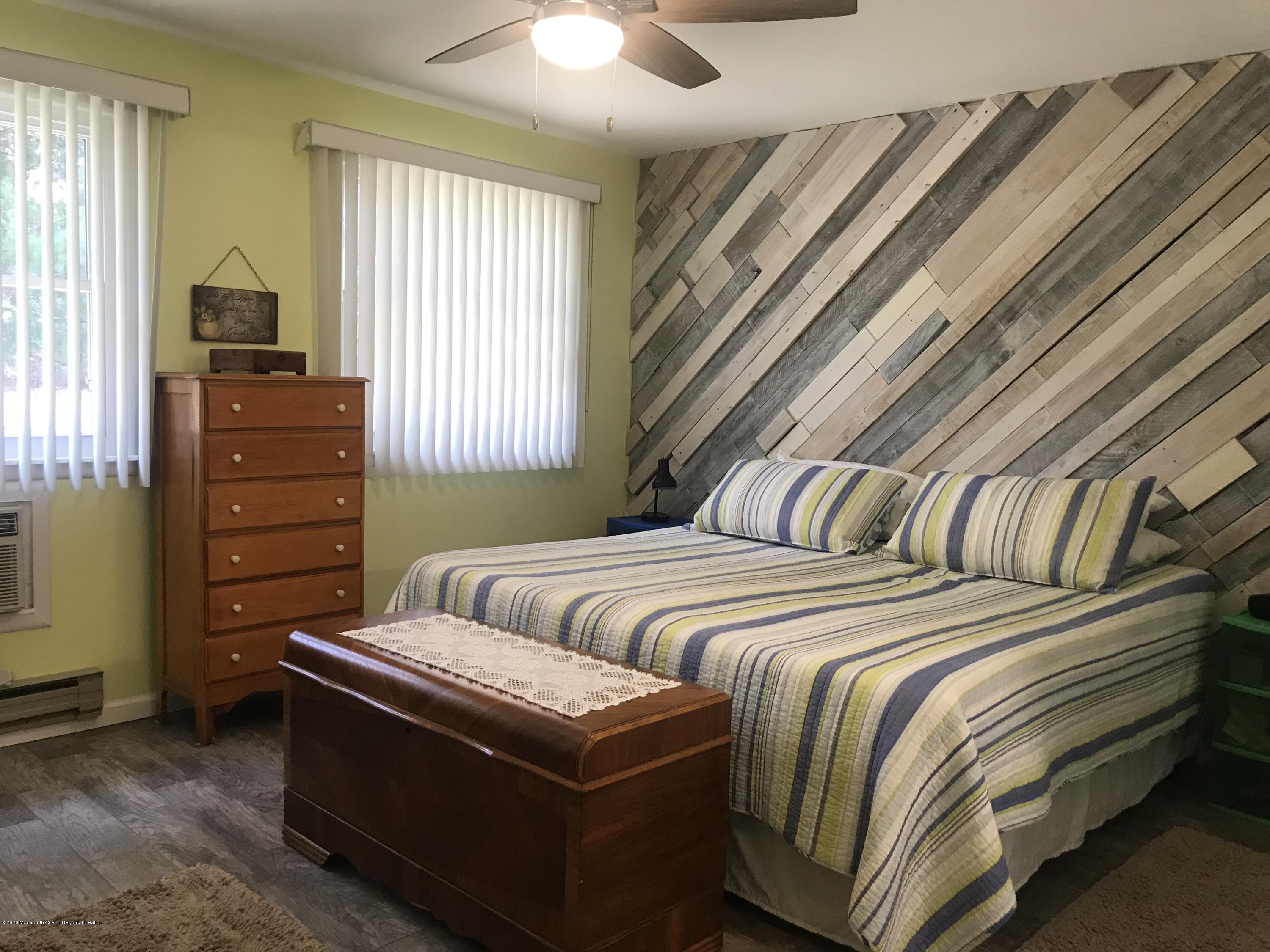 40 A Sunset Road Whiting, NJ 08759 - Photo 9 of 17 a bedroom with a bed and a dresser