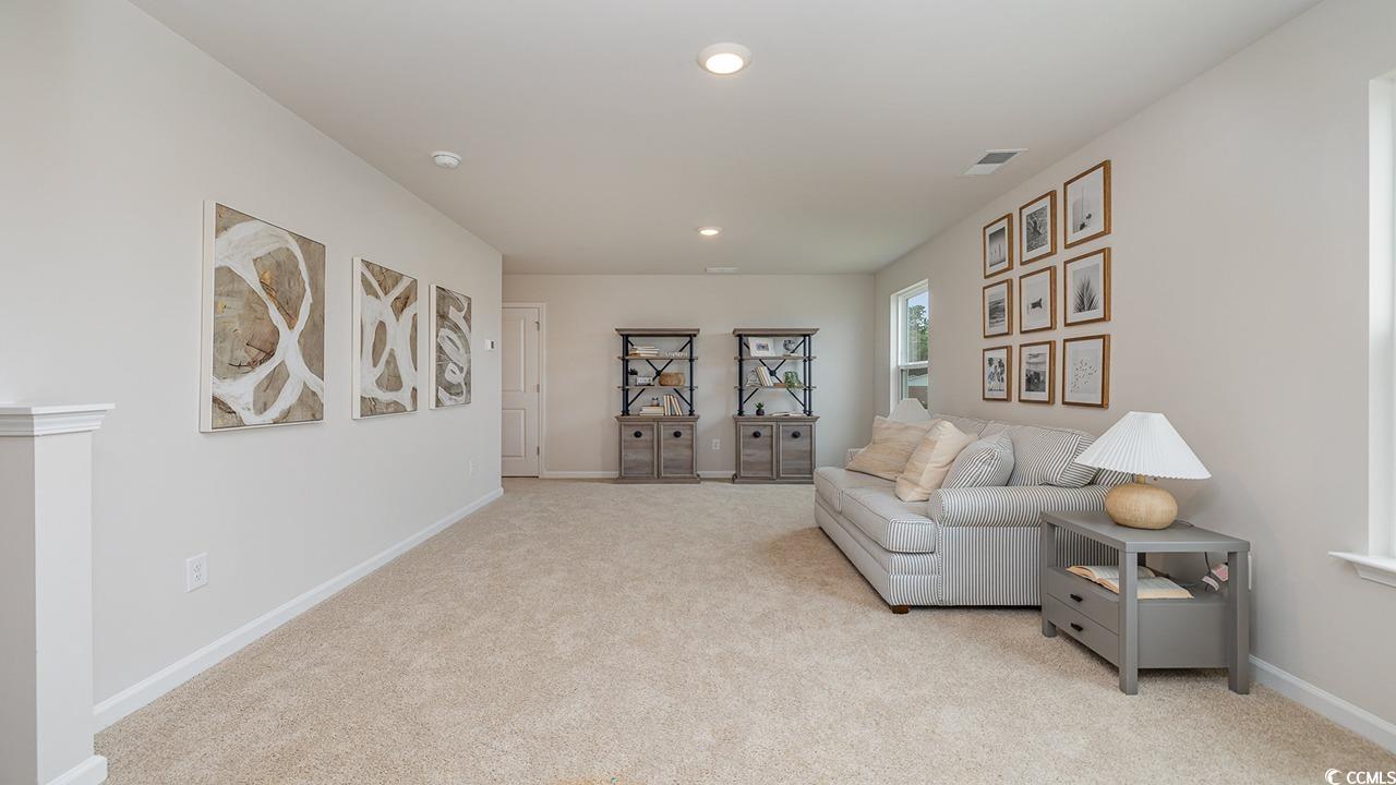 303 Ridley Street Longs, SC 29568 - Photo 20 of 31 Sitting room with light carpet and recessed lighting