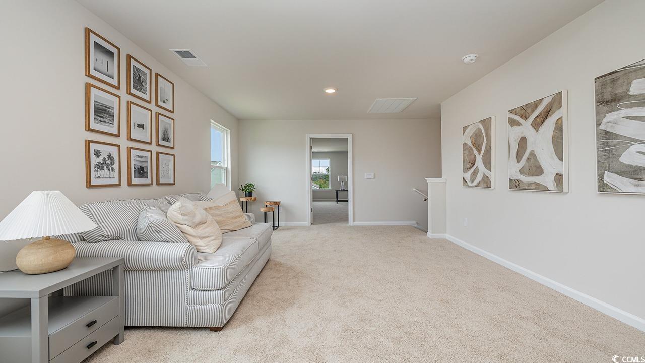 303 Ridley Street Longs, SC 29568 - Photo 21 of 31 Living area featuring light carpet and recessed lighting