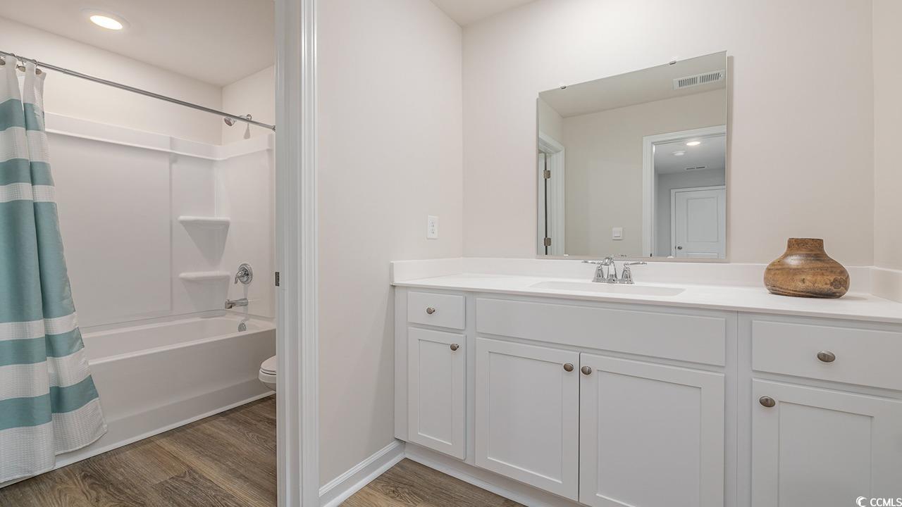303 Ridley Street Longs, SC 29568 - Photo 24 of 31 Full bath featuring vanity, shower / tub combo, light wood-style flooring, and recessed lighting