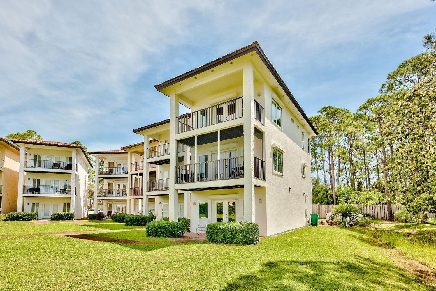 114 Mar-A-Lago Boulevard, Unit 1 Santa Rosa Beach, FL 32459 - Photo 20 of 28 a front view of a building with a garden