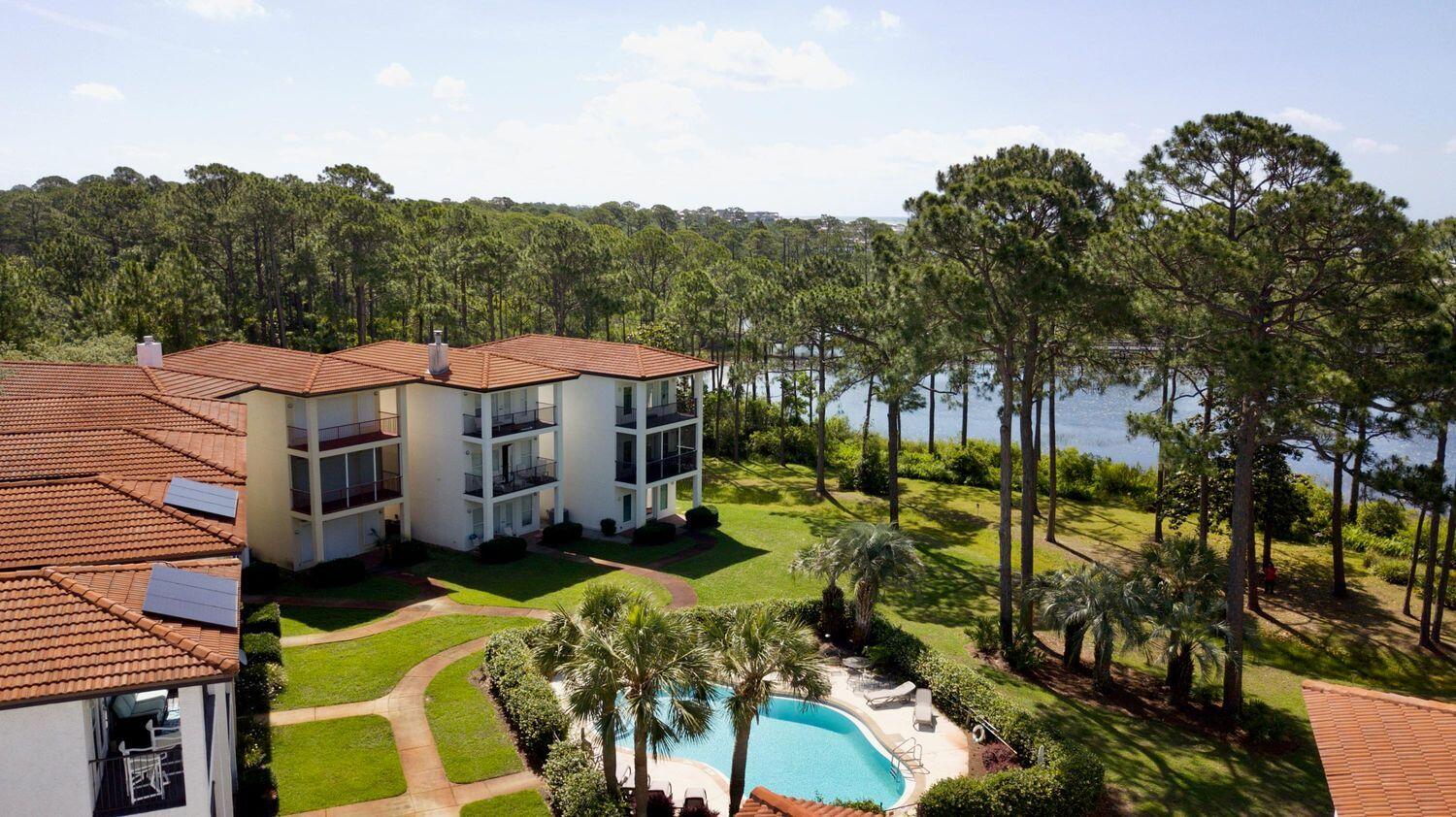 114 Mar-A-Lago Boulevard, Unit 1 Santa Rosa Beach, FL 32459 - Photo 22 of 28 a view of a house with a big yard and large trees