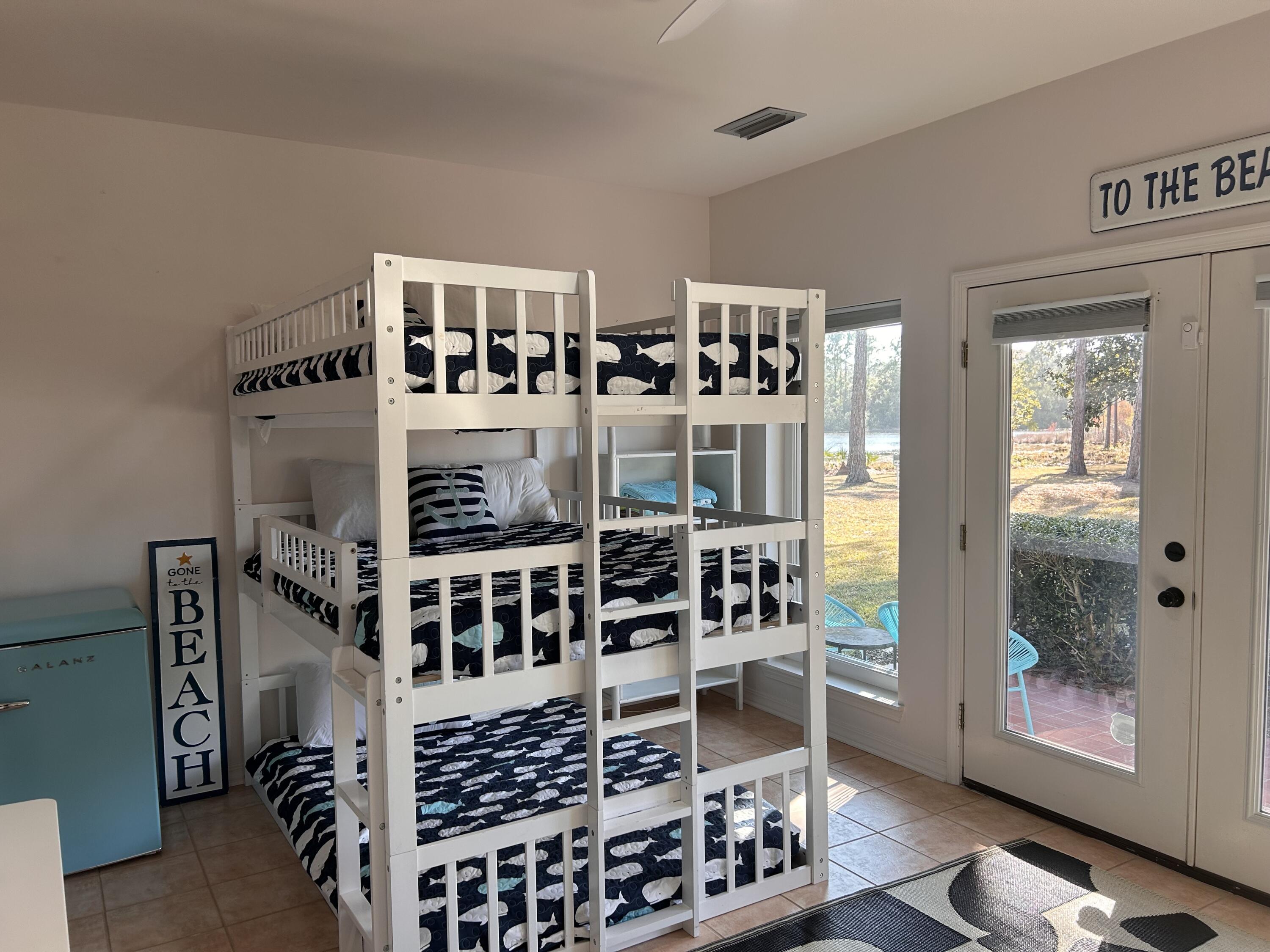 114 Mar-A-Lago Boulevard, Unit 1 Santa Rosa Beach, FL 32459 - Photo 30 of 49 a view of staircase with white walls and windows
