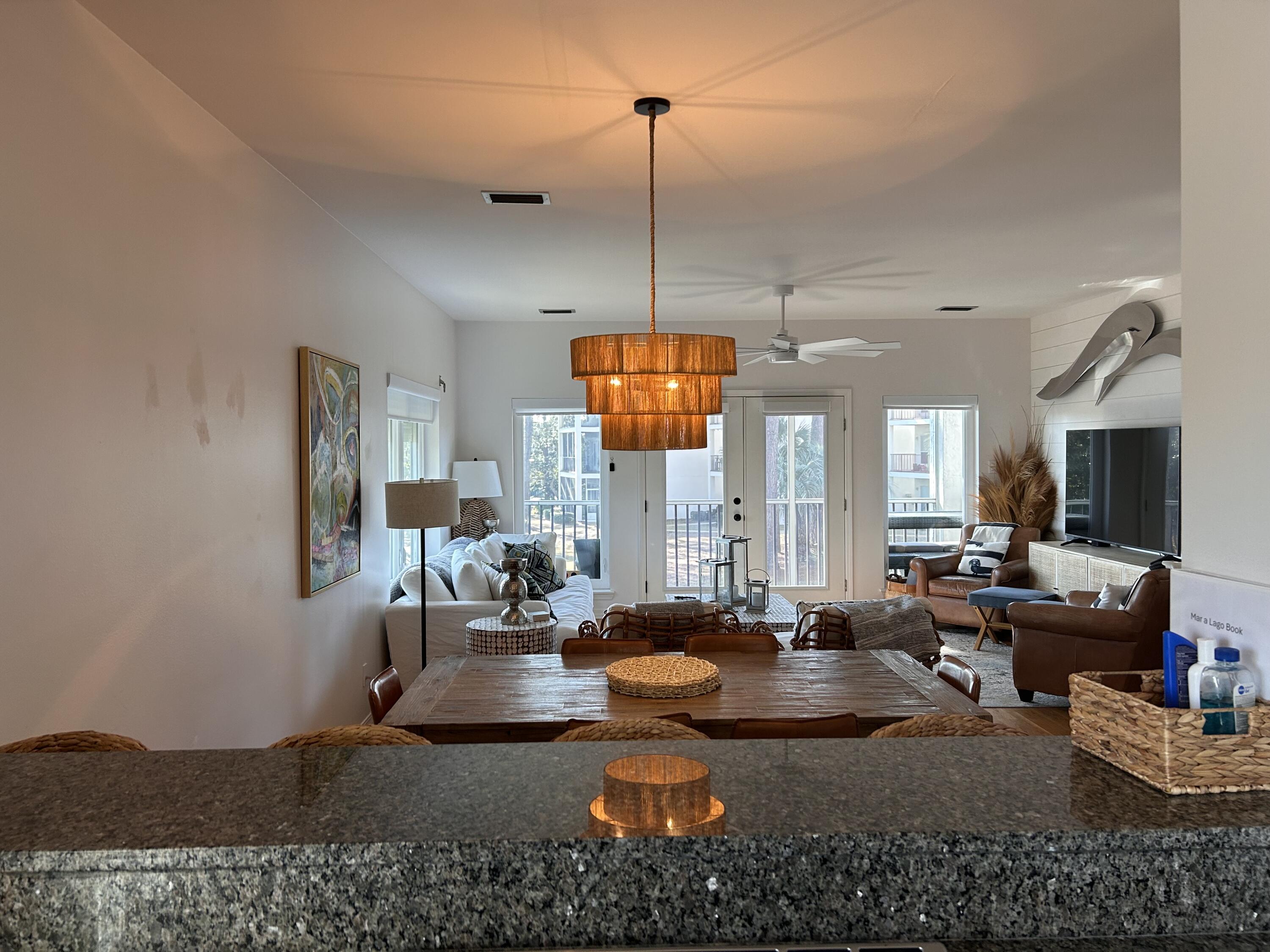 114 Mar-A-Lago Boulevard, Unit 1 Santa Rosa Beach, FL 32459 - Photo 37 of 49 a living room with couches and kitchen view with wooden floor