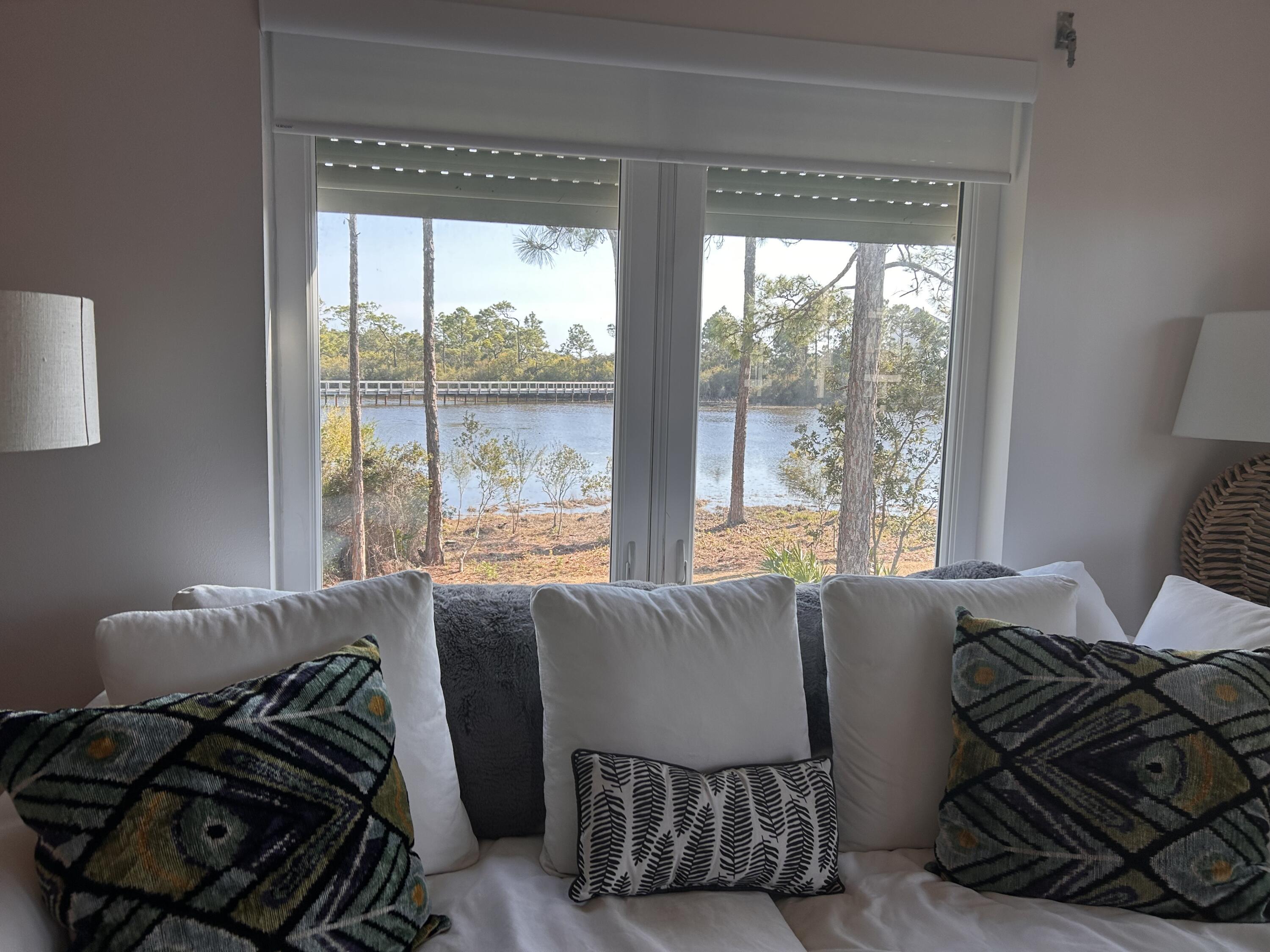 114 Mar-A-Lago Boulevard, Unit 1 Santa Rosa Beach, FL 32459 - Photo 40 of 49 a bed sitting in a bedroom next to a window