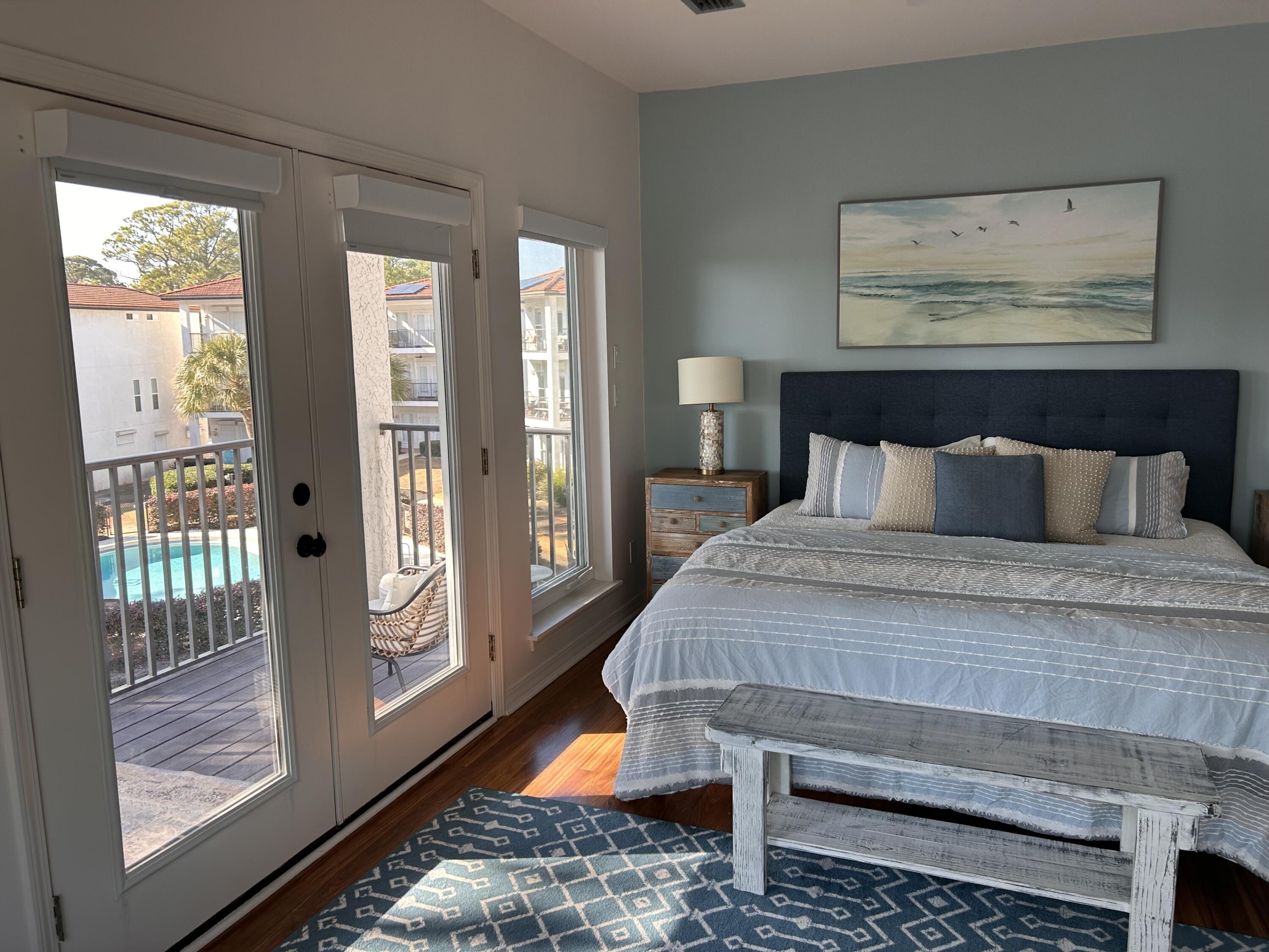 114 Mar-A-Lago Boulevard, Unit 1 Santa Rosa Beach, FL 32459 - Photo 46 of 49 a bedroom with a bed and glass window