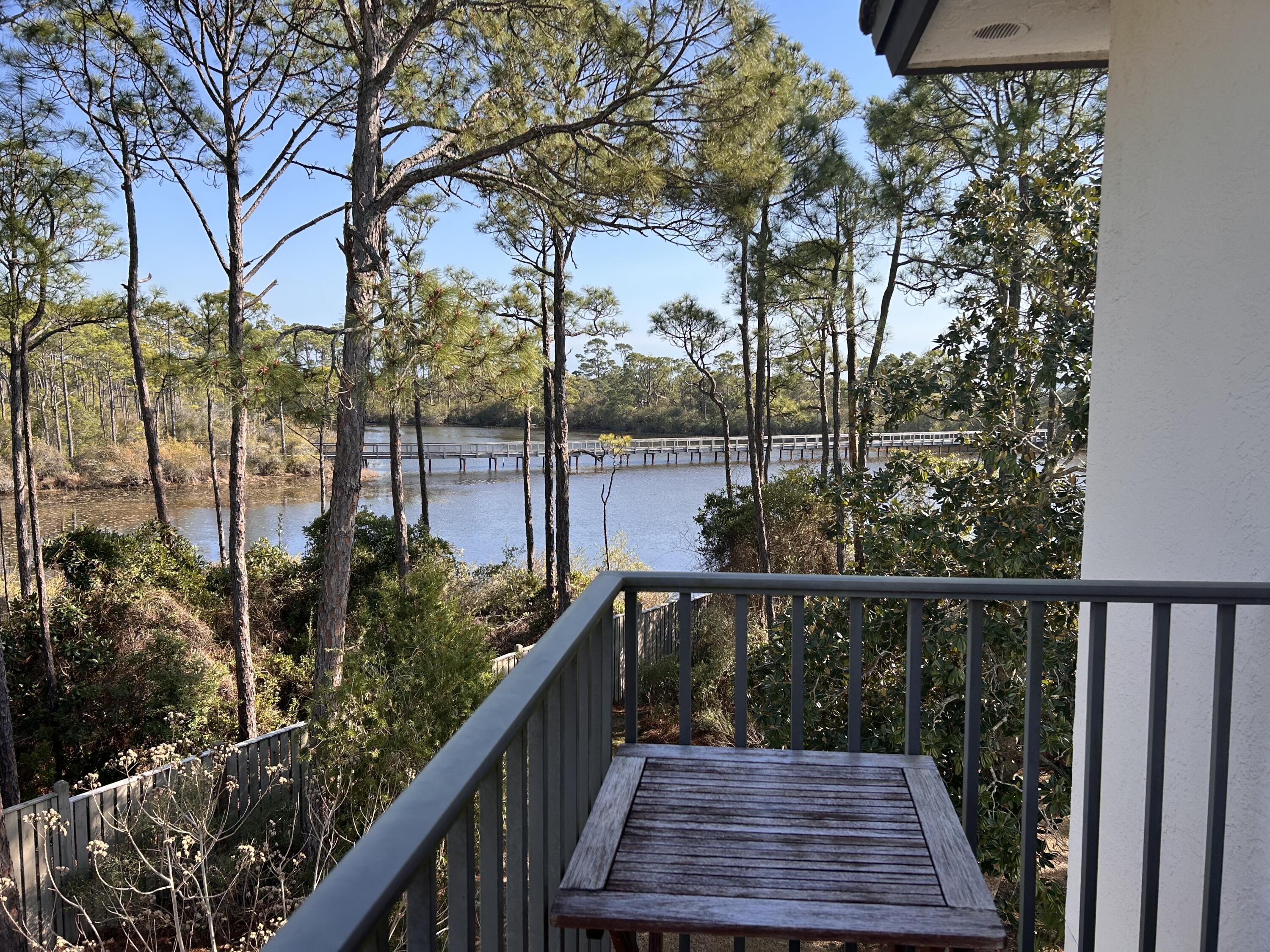 114 Mar-A-Lago Boulevard, Unit 1 Santa Rosa Beach, FL 32459 - Photo 48 of 49 a balcony with wooden floor and outdoor seating