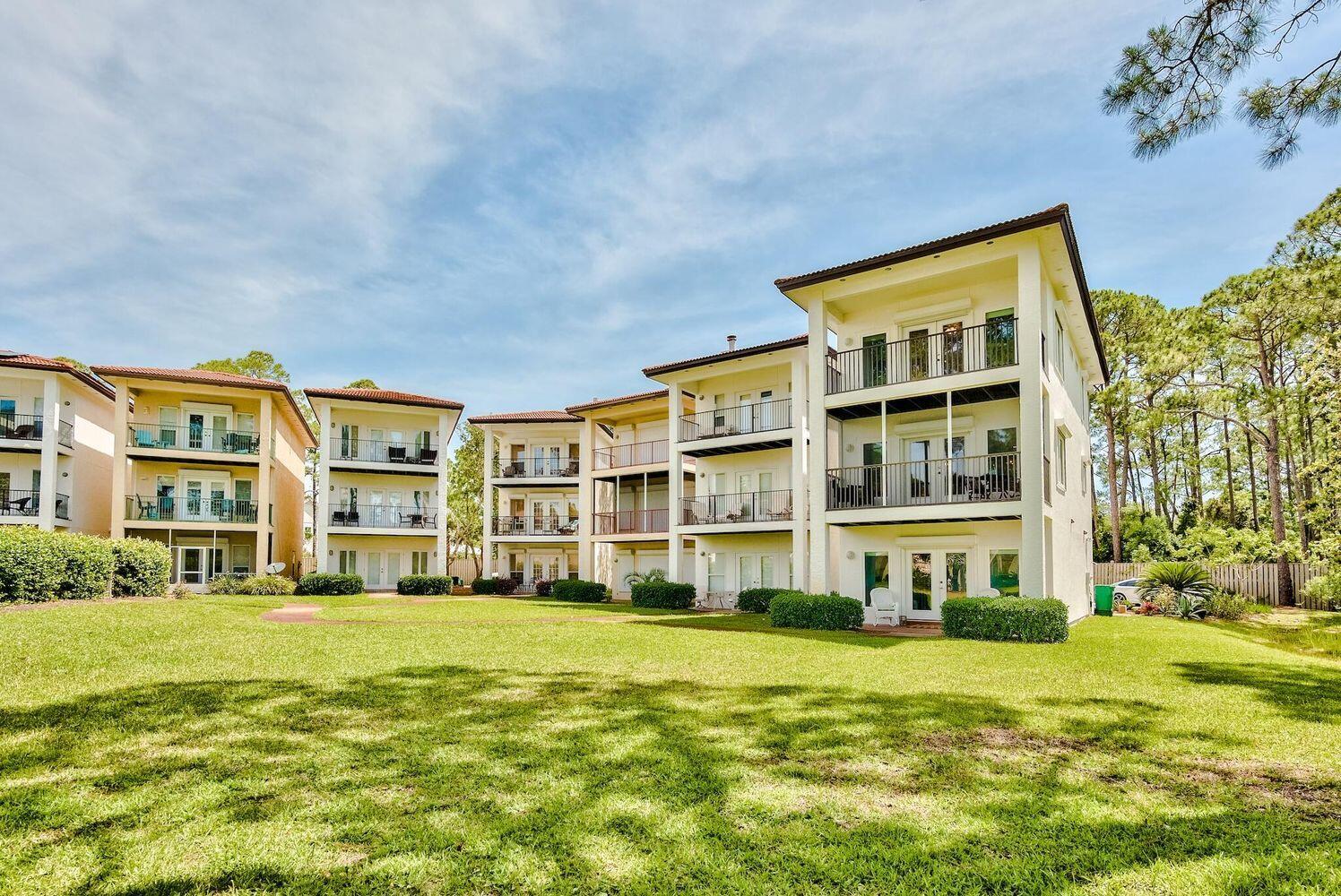 114 Mar-A-Lago Boulevard, Unit 1 Santa Rosa Beach, FL 32459 - Photo 7 of 28 a front view of a building with a garden